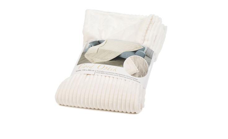 Die Gözze Wohndecke Cord (150x200 cm), cremefarben gerippt und gefaltet mit Etikett, verleiht jedem Sofa gemütliche Eleganz.