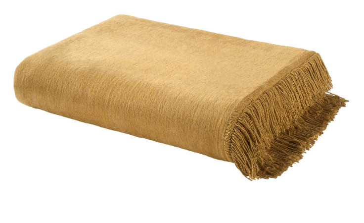 Das Casa Nova Fransenplaid 130 x 170 cm in senfgelb mit Fransen ist ideal für ein Textil Sofa oder eine braune Couch.