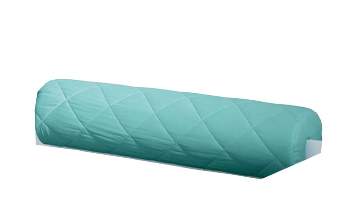 Die Paidi Comfort-Rolle Kidsworld ist ein langes, zylindrisches Türkis-Rollenkissen mit Karosteppung auf weißem Hintergrund.