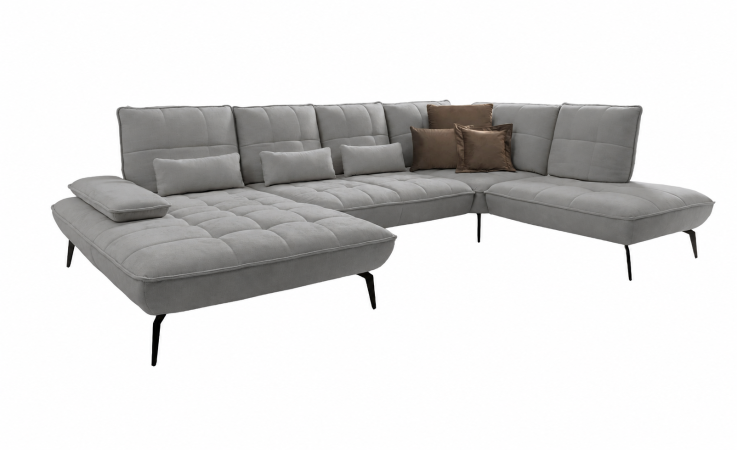 Komfort-Wohnlandschaft „vito Ticona Plus“ von Vito: graues L-förmiges Sofa mit gesteppten Polstern und braun-grauen Zierkissen.