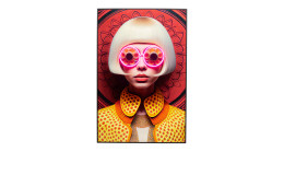 Eine Frau mit Bob trägt eine bunte Plastiksonnenbrille und gelbe Tupfen in Kare's Rahmenbild Fancy Blonde Lady.