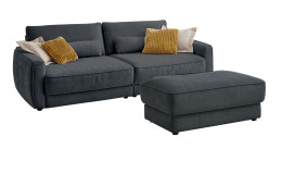Komfort-Big Sofa planoform Cochem in der Farbe Grau mit mehreren Kissen, zwei davon sind braun, und der passende Hocker dazu