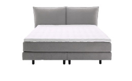 Komfort-Boxspringbett Vita ohne Kissen und Dekoration in einem grauen Stoffbezug.