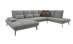 Komfort-Wohnlandschaft „vito Ticona Plus“ von Vito: graues L-förmiges Sofa mit gesteppten Polstern und braun-grauen Zierkissen.