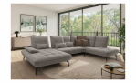 Modernes Wohnzimmer mit der Komfort-Wohnlandschaft „vito Ticona Plus“ von Vito, einem Couchtisch, großen Fenstern und Wandkunst.