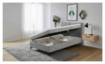 Boxspringbett Carmen – gepolstertes Einzelbett, bei dem die Matratze angehoben wurde, um den Stauraum darunter freizulegen.