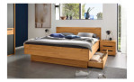 Komfort - Bettgestell Onema, in der Farbausführung Kernbuche, mit offener Schublade, in einem Raum stehend