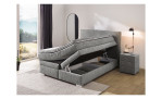 Boxspringbett Taro in der Farbe grau, in einem Raum stehend mit einem geöffneten Bettkasten