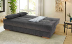 Schlafsofa Cher in der Farbe Dunkelgrau in Liegeform in einem Zimmer