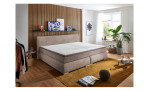 Boxspringbett Family, in der Farbausführung Taupe, in einem Raum stehend ohne Deko