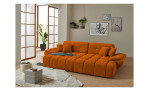 Wohnlandschaft Poppy in Orange mit Relaxfunktion und Ottomane rechts im hellen Raum mit Holzfußboden.