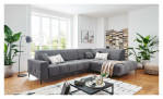 Wohnlandschaft Luan in Grau mit Cord-Optik, inszeniert auf gemustertem Teppich mit schwarzem Couchtisch und Stehlampe.