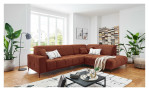 Wohnlandschaft Luan in Orange mit Cord-Optik, inszeniert auf gemustertem Teppich mit schwarzem Couchtisch und Stehlampe.