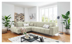 Wohnlandschaft Luan in Creme mit Cord-Optik, inszeniert auf gemustertem Teppich mit schwarzem Couchtisch und Stehlampe.