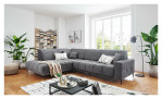 Wohnlandschaft Luan in Grau mit Cord-Optik, inszeniert auf gemustertem Teppich mit schwarzem Couchtisch und Stehlampe.