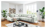 Wohnlandschaft Luan in Weiß mit Cord-Optik, inszeniert auf gemustertem Teppich mit schwarzem Couchtisch und Stehlampe.