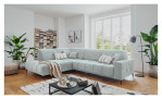 Wohnlandschaft Luan in Mint mit Cord-Optik, inszeniert auf gemustertem Teppich mit schwarzem Couchtisch und Stehlampe.