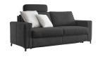 Hukla Komfort-Schlafsofa „Pickering“ in Dunkelgrau mit zwei hellgrauen Kissen und einer Kopfstütze, vor weißem Hintergrund.