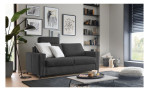 Modernes Wohnzimmer mit einem Komfort-Schlafsofa „Pickering“ von Hukla, Wandbildern, Zimmerpflanzen, Regalen und schwarzen Jalousien.