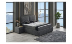 Modernes Schlafzimmer mit einem Polsterbett „Rumi“, zwei Nachttischen, großen Fenstern, Bergblick und einer Zimmerpflanze.