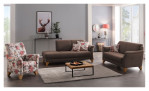 Modernes Wohnzimmer mit der Mondo Komfort-Sitzgruppe MONDO Quadra: braune Sofas, Sessel mit Blumenmuster, Teppich, Tisch und Wandbild mit Hirschmotiv.