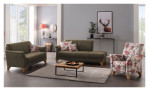 Modernes Wohnzimmer mit der Mondo Komfort-Sitzgruppe MONDO Quadra, Sofas, einem Sessel mit Blumenmuster, einem Couchtisch und Wandkunst.