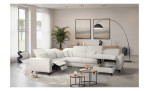 Modernes Wohnzimmer mit einer Vito Komfort-Wohnlandschaft „vito Wisom“, Couchtischen, einer Stehlampe, abstrakter Kunst und einem großen Fenster.