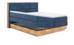 Boxspringbett MONDO NATUR Incana in einem Stoffbezug in Dark Blue und einem Sichtholzrahmen in Eiche. Mit geöffneten Bettkasten