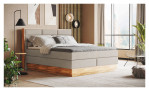 Boxspringbett MONDO NATUR Incana in einem Stoffbezug in Natural und einem Sichtholzrahmen in Eiche Auf einem dekorierten Hintergrund