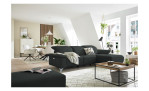 Komfort - Ecksofa Musterring MR 370, in der Farbausführung anthrazit mit einem Hocker, in einem Raum stehend