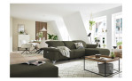 Komfort - Ecksofa Musterring MR 370, in der Farbausführung olive mit einem Hocker, in einem Raum stehend